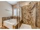 Bathroom featuring shower with glass door and separate soaking tub at 2601 Bechamel Pl, Henderson, NV 89044