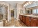 Main bathroom boasts a double vanity, tiled shower, and access to walk-in closet at 2601 Bechamel Pl, Henderson, NV 89044