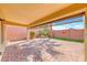 Covered patio with brick flooring, manicured landscaping, and a privacy wall at 2601 Bechamel Pl, Henderson, NV 89044