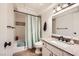 Neat bathroom featuring a vanity with a granite countertop and a bathtub with shower at 2748 Heritage Cir, Las Vegas, NV 89121