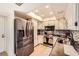 Well-equipped kitchen featuring stainless steel refrigerator, microwave and a stylish backsplash at 2748 Heritage Cir, Las Vegas, NV 89121