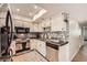 Well-lit kitchen featuring updated appliances, wooden floors, and ample cabinet space at 2748 Heritage Cir, Las Vegas, NV 89121