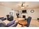 Comfortable living room featuring hardwood floors, a ceiling fan, a brick fireplace, and stylish furnishings at 2748 Heritage Cir, Las Vegas, NV 89121