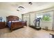 Spacious bedroom with wood floors, large windows, a ceiling fan, and exercise equipment at 2748 Heritage Cir, Las Vegas, NV 89121