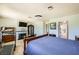 Bright bedroom featuring a cozy fireplace, entertainment center, and a comfortable bed at 2748 Heritage Cir, Las Vegas, NV 89121