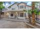 View of the home's backyard, showing a covered patio, palm trees, and balcony at 2808 Deep Water Cir, Las Vegas, NV 89117