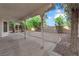 Large backyard area includes a covered patio, trees, and a block wall at 2808 Deep Water Cir, Las Vegas, NV 89117