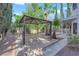 Backyard includes a covered pergola, palm trees, and mature landscaping at 2808 Deep Water Cir, Las Vegas, NV 89117