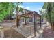 Backyard view with pergola, patio area, and lush trees at 2808 Deep Water Cir, Las Vegas, NV 89117