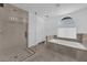 Beautiful bathroom featuring a glass-enclosed shower, a separate soaking tub, and ample natural light at 2808 Deep Water Cir, Las Vegas, NV 89117