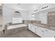 Luxurious bathroom features a soaking tub, double sink vanity, and tiled floor, creating a spa-like retreat at 2808 Deep Water Cir, Las Vegas, NV 89117
