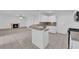 Bright kitchen with white cabinetry, granite countertops, and an open layout to the living area with fireplace at 2808 Deep Water Cir, Las Vegas, NV 89117