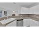 Kitchen featuring granite counters, white cabinets, and stainless steel appliances with a view into the living area at 2808 Deep Water Cir, Las Vegas, NV 89117