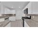 Bright kitchen featuring granite countertops, stainless steel appliances, and white cabinetry with matching backsplash at 2808 Deep Water Cir, Las Vegas, NV 89117