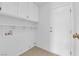 Laundry room features upper cabinets, a shelf, and a door to the outside at 2808 Deep Water Cir, Las Vegas, NV 89117