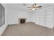 Bright living room features a fireplace, ceiling fan, and built-in shelving at 2808 Deep Water Cir, Las Vegas, NV 89117