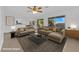 Virtually staged living room with comfortable seating, a modern rug, and a view of the kitchen and dining area at 2808 Deep Water Cir, Las Vegas, NV 89117