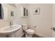 Charming bathroom with a vessel sink, white cabinetry, and a round mirror at 2845 Copper Wind Ln # 4, Las Vegas, NV 89183