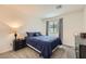 Cozy bedroom featuring a comfortable bed with blue comforter, a nightstand, and soft carpet at 2845 Copper Wind Ln # 4, Las Vegas, NV 89183