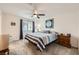 Cozy bedroom features a queen-size bed, ceiling fan, carpeted floors, and natural light at 2845 Copper Wind Ln # 4, Las Vegas, NV 89183
