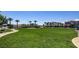 Large grassy park area with sidewalks, landscaping, and a clear view of nearby homes on a sunny day at 2845 Copper Wind Ln # 4, Las Vegas, NV 89183