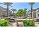 Enjoy outdoor picnic area with many tables, shade trees, palm trees, and barbecue grill at 2845 Copper Wind Ln # 4, Las Vegas, NV 89183