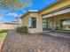 Paver patio leading to a home with green lawn and desert landscaping at 3008 Barrett Springs Ave, Henderson, NV 89044