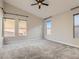 Spacious bedroom with a ceiling fan and multiple windows offering natural light and neighborhood views at 3008 Barrett Springs Ave, Henderson, NV 89044