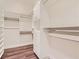 Well-organized walk-in closet with custom shelving, drawers, and hardwood floors for ample storage at 3008 Barrett Springs Ave, Henderson, NV 89044