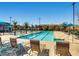 Large swimming pool with lane markers, lounge chairs and umbrellas for relaxing by the water at 3008 Barrett Springs Ave, Henderson, NV 89044