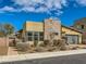 Landscaped front yard of a single story home featuring desert landscaping with a stone accent wall at 3008 Barrett Springs Ave, Henderson, NV 89044