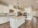 Modern kitchen featuring stainless steel appliances, an island, and pendant lighting at 3008 Barrett Springs Ave, Henderson, NV 89044