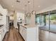 Bright kitchen featuring a kitchen island, stainless steel appliances and an outdoor patio area at 3008 Barrett Springs Ave, Henderson, NV 89044