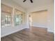 Living room with dark wood floors, white trim, and large windows overlooking backyard at 3008 Barrett Springs Ave, Henderson, NV 89044