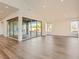 Bright living room featuring hardwood floors, large windows, and a sliding glass door to the outdoor patio at 3008 Barrett Springs Ave, Henderson, NV 89044