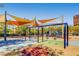 Community playground area with sunshades and swings for residents to enjoy at 3008 Barrett Springs Ave, Henderson, NV 89044