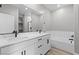 Elegant bathroom featuring double sinks, quartz counters, modern fixtures, and a separate soaking tub at 3241 Walker River St, North Las Vegas, NV 89032