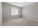 Serene bedroom with plush carpet, window with blinds, and ample natural light at 3241 Walker River St, North Las Vegas, NV 89032