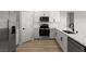 Modern kitchen with stainless steel appliances, white cabinets, quartz countertops, and tile backsplash at 3241 Walker River St, North Las Vegas, NV 89032