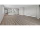 Spacious living room featuring modern flooring and an open layout that leads to the kitchen area at 3241 Walker River St, North Las Vegas, NV 89032