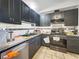 Galley kitchen features black cabinets, white and black backsplash, and stainless steel appliances at 4009 Patterson Ave, Las Vegas, NV 89104