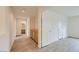 Inviting hallway with wood-look floors, built-in storage, and neutral paint at 4045 Oliver Sagebrush Dr, Las Vegas, NV 89122
