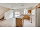 Open kitchen with light wood cabinets, an island, and modern appliances, seamlessly connecting to the living area at 4045 Oliver Sagebrush Dr, Las Vegas, NV 89122