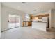 Bright kitchen and dining area with light wood cabinets, island, stainless steel appliances, and sliding door access at 4045 Oliver Sagebrush Dr, Las Vegas, NV 89122