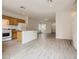 Open-concept kitchen featuring light wood cabinets, an island, and stainless steel appliances, perfect for entertaining at 4045 Oliver Sagebrush Dr, Las Vegas, NV 89122