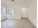 Bright, airy living room featuring wood-look flooring, ample natural light, and a clean, neutral color scheme at 4045 Oliver Sagebrush Dr, Las Vegas, NV 89122