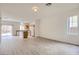Open living area featuring modern wood flooring, white walls, and access to the kitchen and backyard at 4045 Oliver Sagebrush Dr, Las Vegas, NV 89122