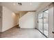 Bright and open living space with modern flooring, a sliding glass door, and convenient access to the upper level at 4045 Oliver Sagebrush Dr, Las Vegas, NV 89122