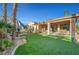 Lush backyard with artificial turf, covered patio, and desert landscaping, perfect for outdoor living at 4379 Bella Cascada St, Las Vegas, NV 89135