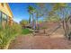 Backyard with a hammock, artificial turf, mature trees, and a rock landscape at 4379 Bella Cascada St, Las Vegas, NV 89135